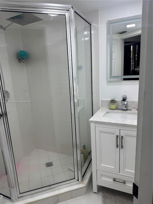 bathroom with vanity and an enclosed shower