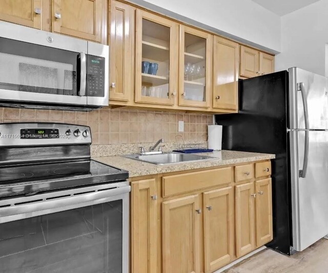 kitchen with white cabinets, light wood-type flooring, light stone counters, and electric stove