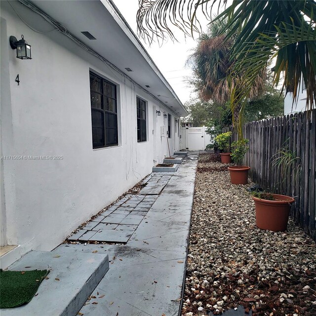 property entrance with a lawn and central air condition unit