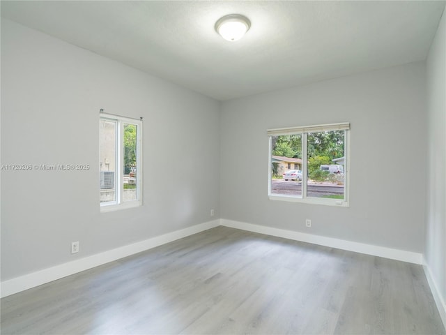 spare room featuring light wood-type flooring