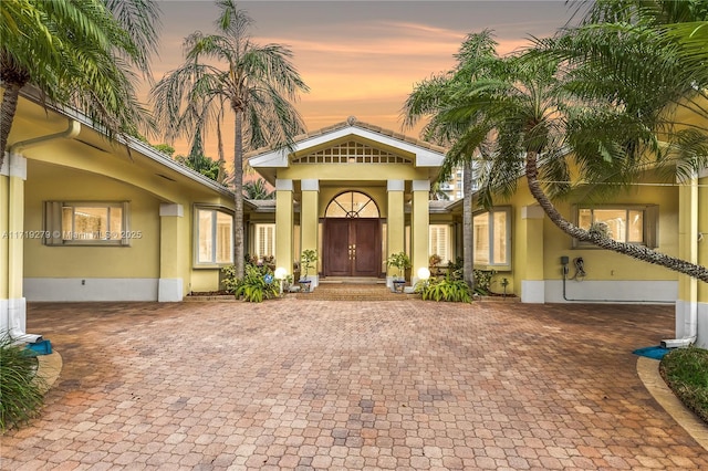 view of exterior entry at dusk