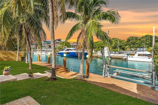 dock area featuring a yard and a water view