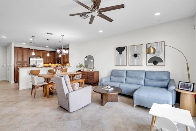 living room with ceiling fan with notable chandelier