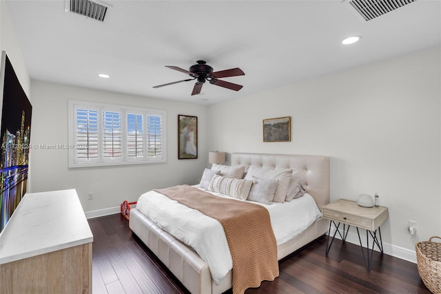 bedroom with dark hardwood / wood-style flooring and ceiling fan