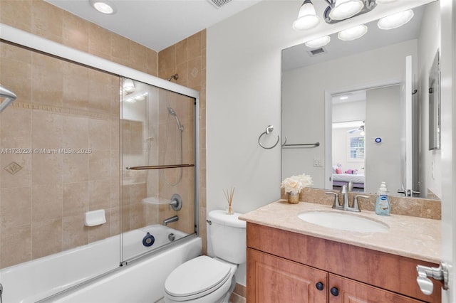 full bathroom featuring vanity, toilet, and bath / shower combo with glass door