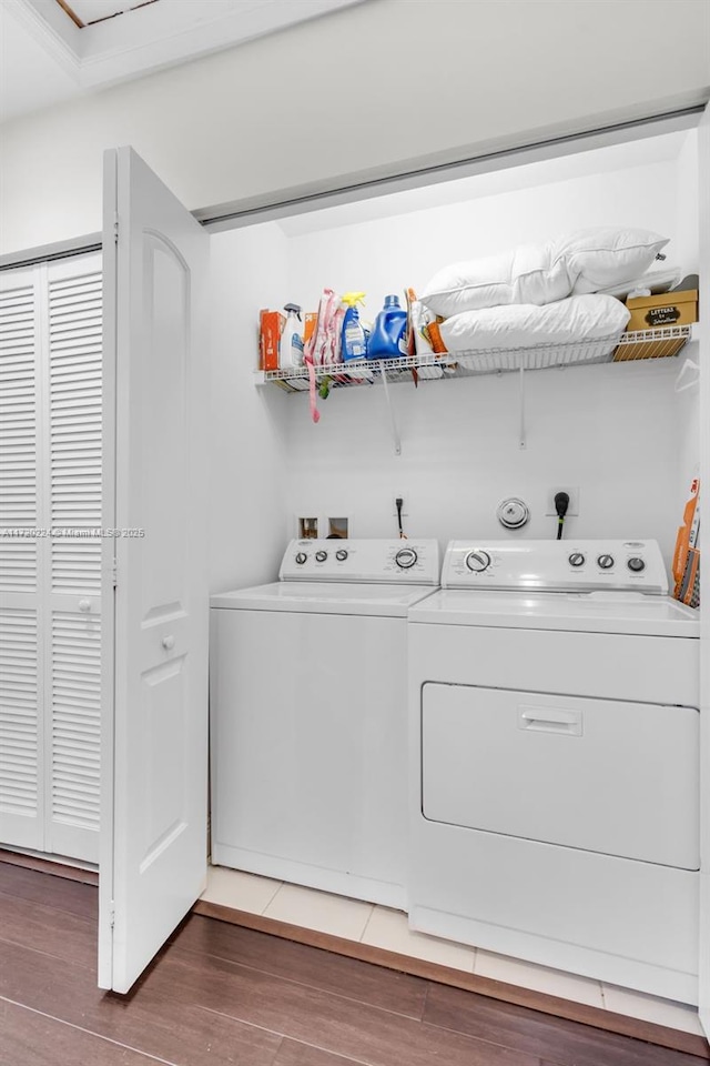 laundry room featuring washing machine and dryer and dark wood-type flooring