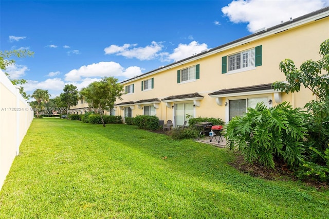 rear view of property featuring a yard