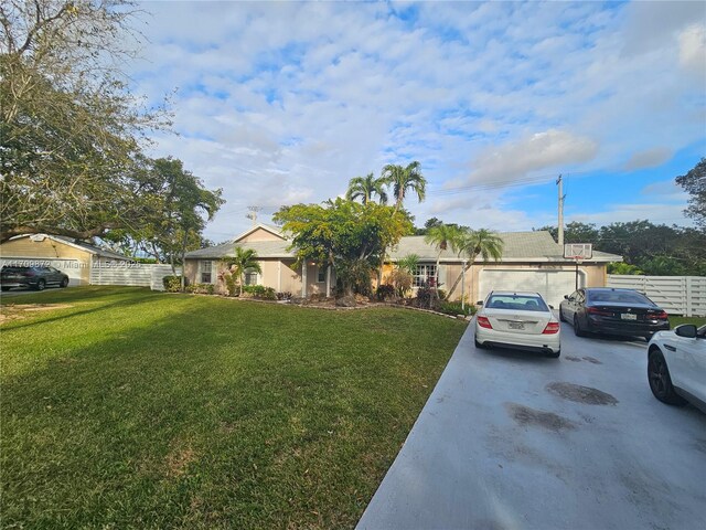 single story home featuring a garage and a front lawn