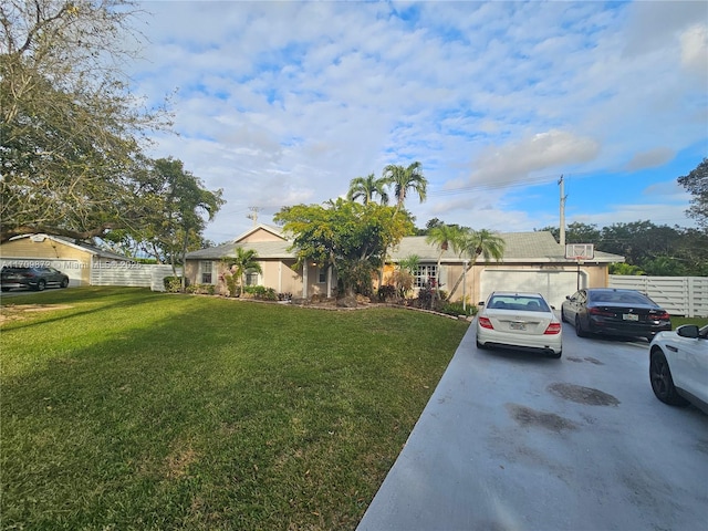 single story home featuring a garage and a front lawn