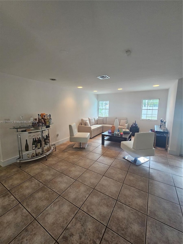 14461 SW 152nd Ct, Miami, FL 33196 - unfurnished living room featuring tile patterned flooring, baseboards, and a healthy amount of sunlight