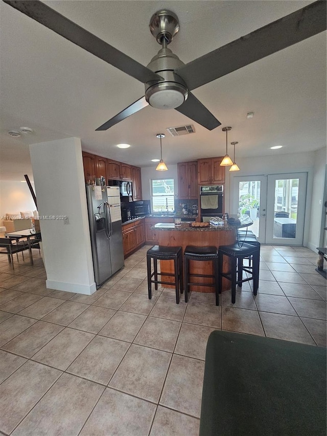 14461 SW 152nd Ct, Miami, FL 33196 - kitchen featuring hanging light fixtures, light tile patterned flooring, ceiling fan, visible vents, and black appliances