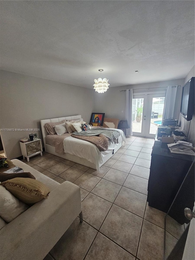 14461 SW 152nd Ct, Miami, FL 33196 - bedroom with a textured ceiling, light tile patterned floors, french doors, and access to outside