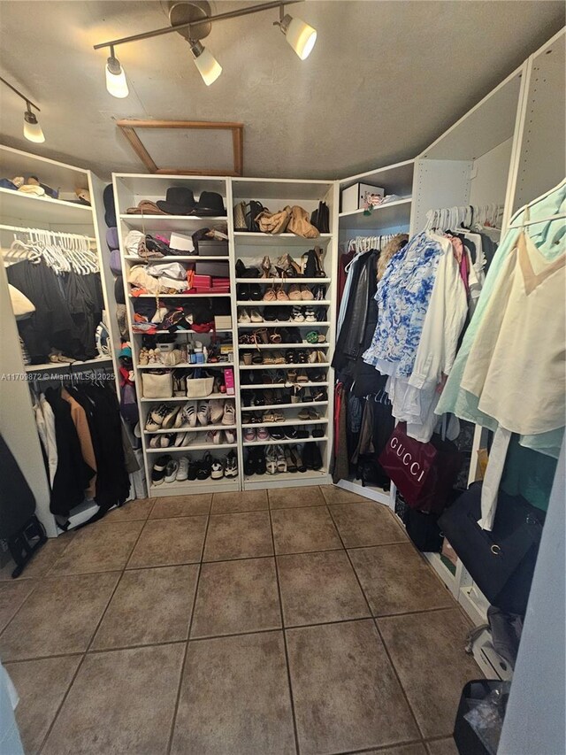 14461 SW 152nd Ct, Miami, FL 33196 - walk in closet featuring tile patterned floors and attic access