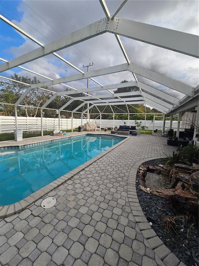 14461 SW 152nd Ct, Miami, FL 33196 - view of swimming pool featuring a fenced in pool, a lanai, fence, and a patio area