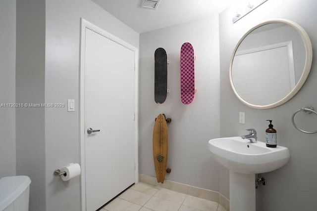 bathroom featuring tile patterned flooring and toilet