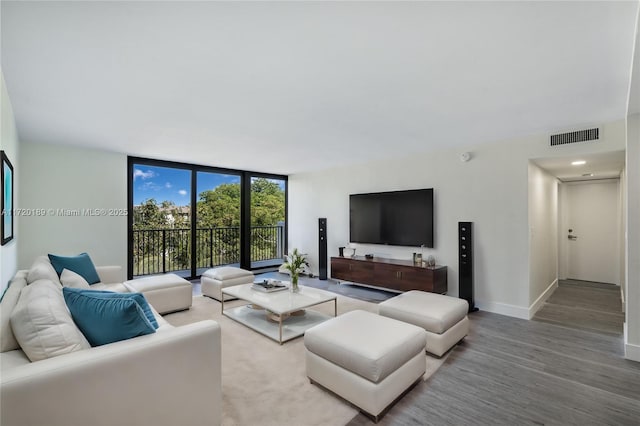 living room featuring floor to ceiling windows