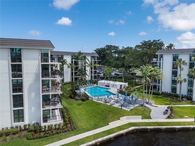 view of swimming pool featuring a yard and a patio