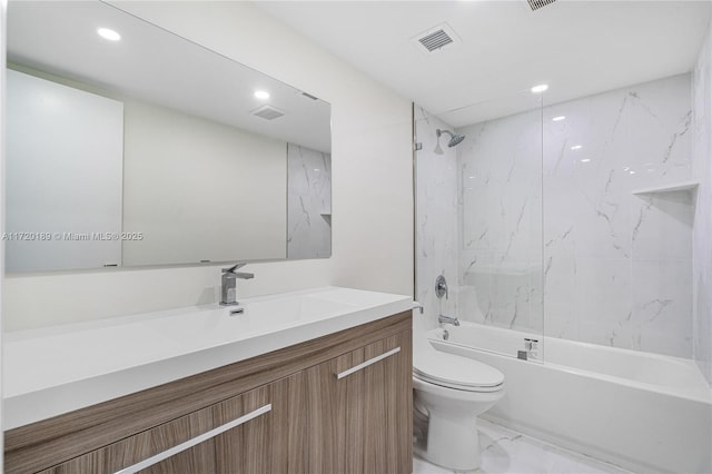 full bathroom with toilet, vanity, and tiled shower / bath