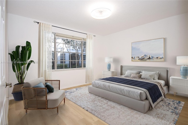 bedroom with hardwood / wood-style flooring