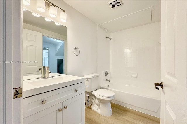 full bathroom with vanity, toilet, shower / bath combination, and hardwood / wood-style floors