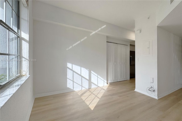 unfurnished room with light wood-type flooring