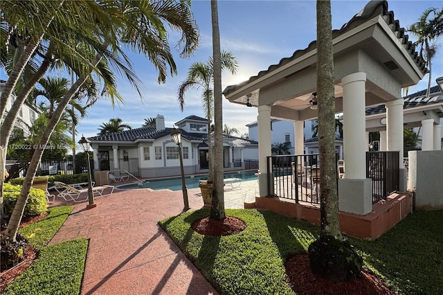 exterior space featuring ceiling fan, a community pool, and a patio