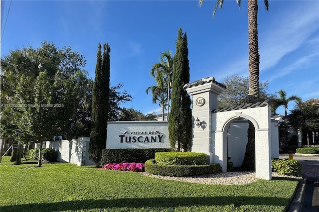 community / neighborhood sign with a yard