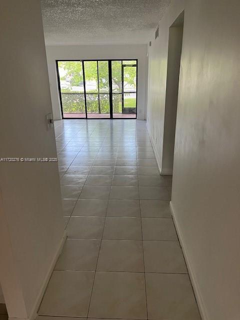 corridor featuring tile patterned floors