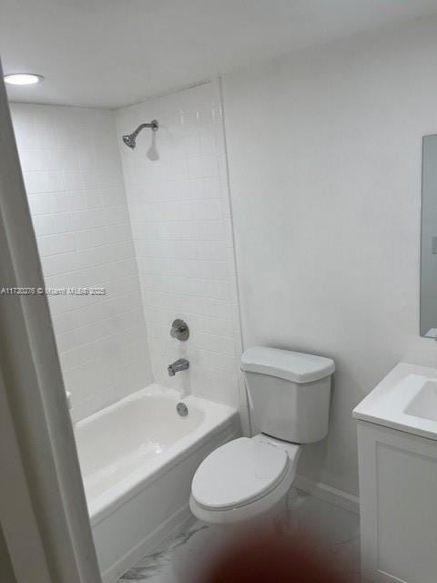 full bathroom with toilet, vanity, and tiled shower / bath