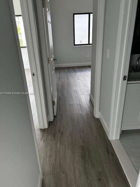 301 NW 28th Ave, Fort Lauderdale, FL 33311 - corridor with dark wood-type flooring and plenty of natural light
