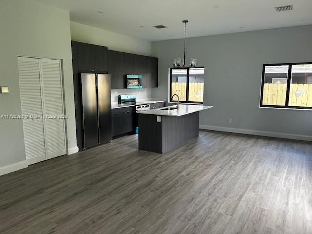 301 NW 28th Ave, Fort Lauderdale, FL 33311 - kitchen featuring freestanding refrigerator, open floor plan, light countertops, dark wood-type flooring, and a center island with sink