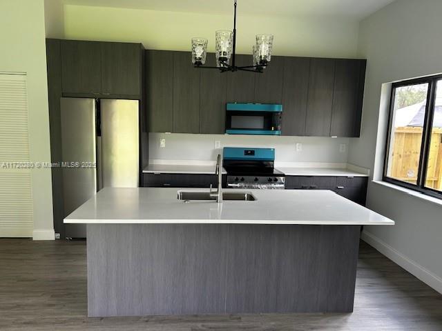 301 NW 28th Ave, Fort Lauderdale, FL 33311 - kitchen featuring stainless steel range oven, light countertops, refrigerator, and dark wood-style flooring