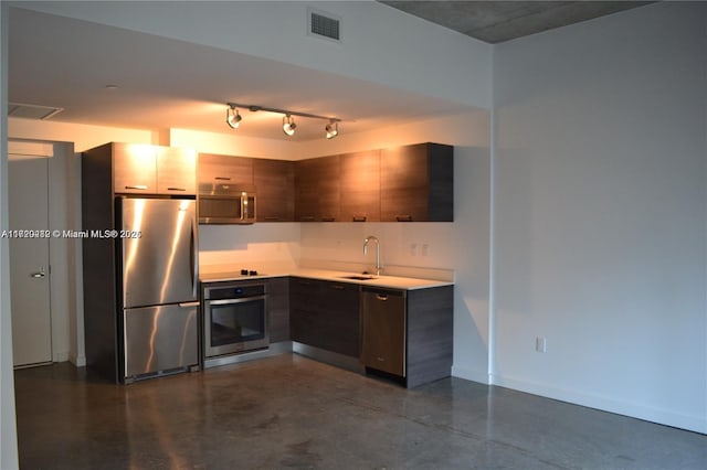 kitchen featuring dark brown cabinetry, sink, and appliances with stainless steel finishes