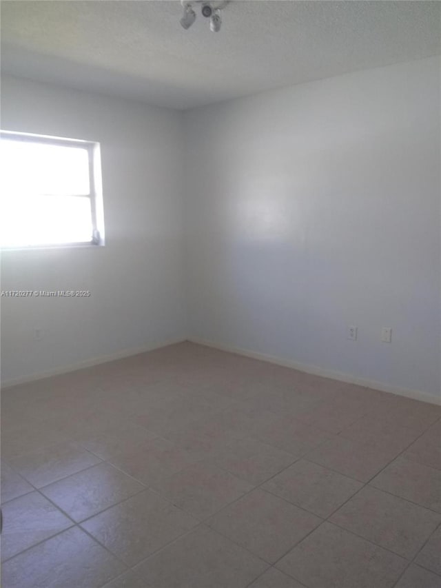 empty room featuring light tile patterned floors