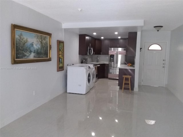 washroom with separate washer and dryer and sink