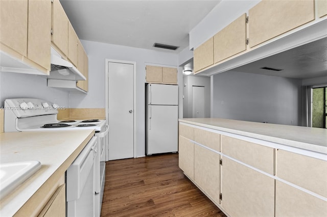 kitchen with dark hardwood / wood-style floors, white appliances, and sink