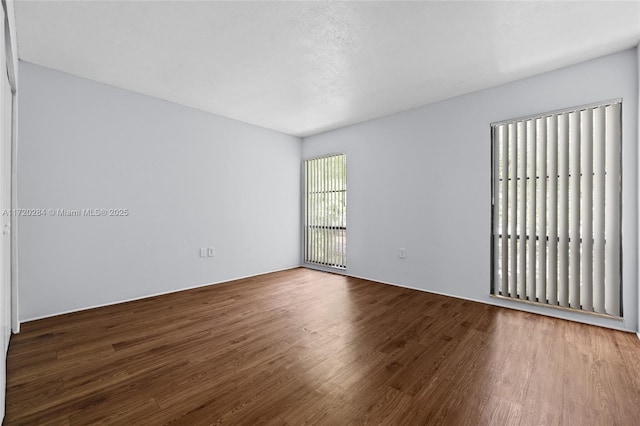 spare room with wood-type flooring