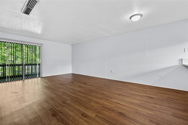 empty room featuring hardwood / wood-style floors and a textured ceiling