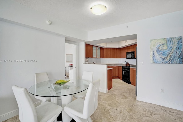 dining area featuring a tray ceiling