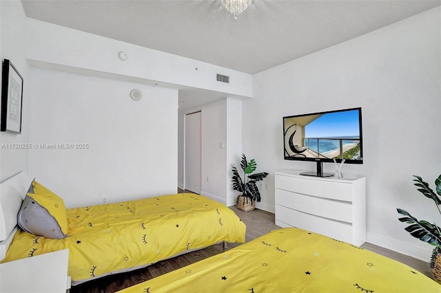 bedroom featuring hardwood / wood-style floors and a closet