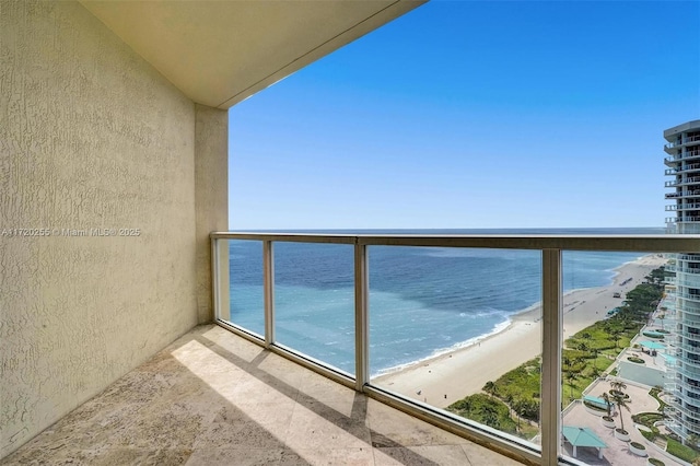 balcony with a beach view and a water view