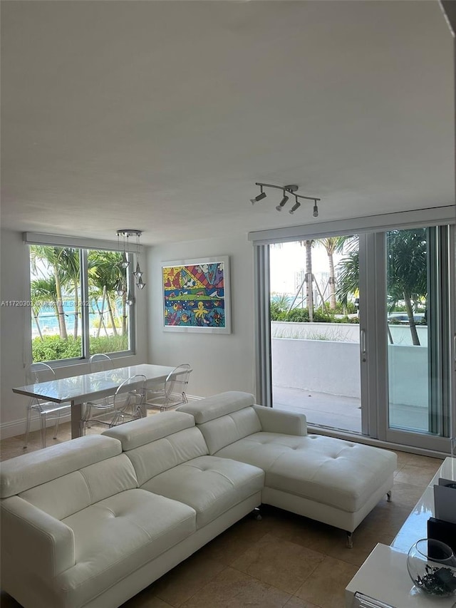 living room with tile patterned flooring and plenty of natural light