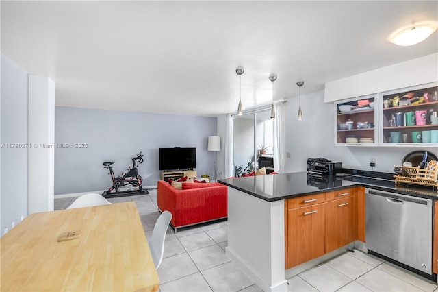 kitchen with dishwasher, dark stone counters, hanging light fixtures, light tile patterned floors, and kitchen peninsula