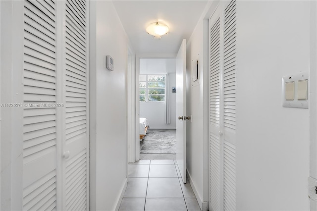 hall featuring light tile patterned floors