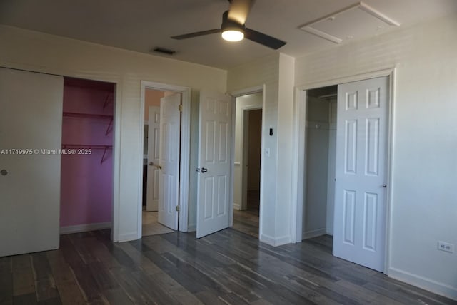 unfurnished bedroom with ceiling fan and dark wood-type flooring