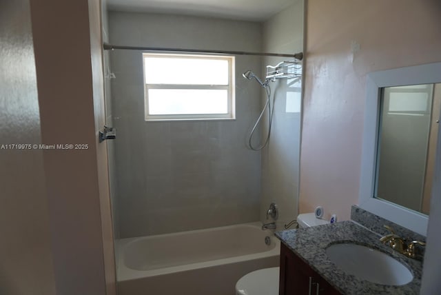 full bathroom featuring vanity, toilet, and tiled shower / bath