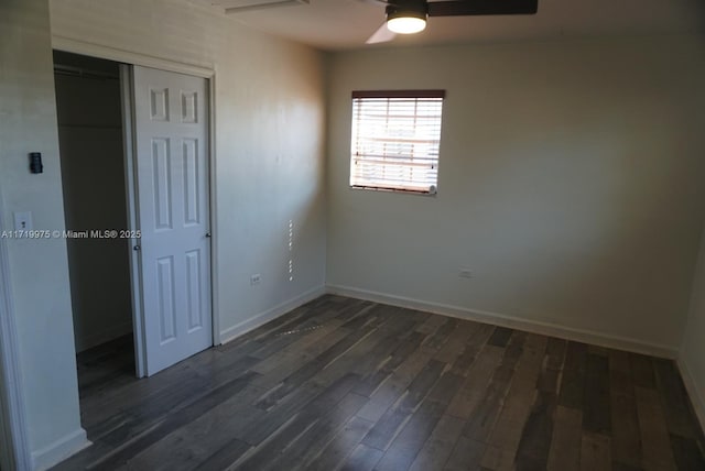 unfurnished room with ceiling fan and dark hardwood / wood-style flooring