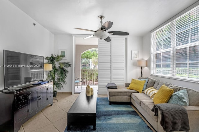 living room featuring light tile patterned floors and ceiling fan