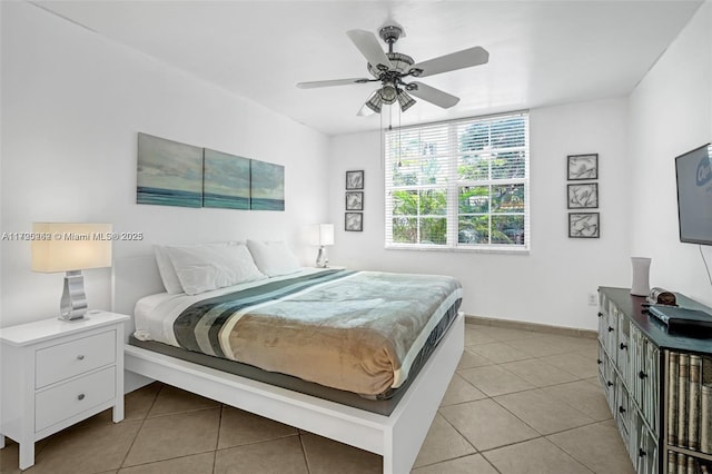 tiled bedroom featuring ceiling fan