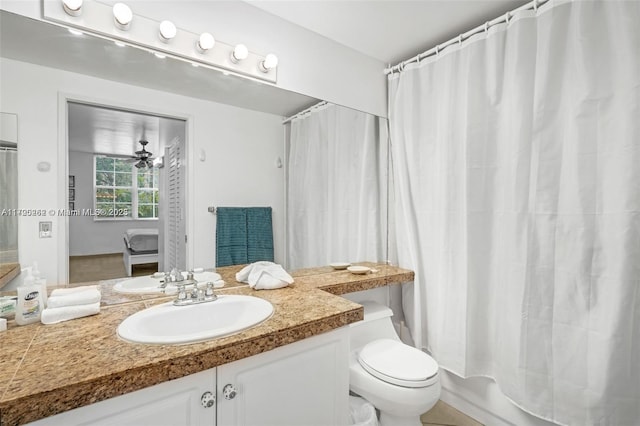 full bathroom with ceiling fan, vanity, shower / bath combo, and toilet